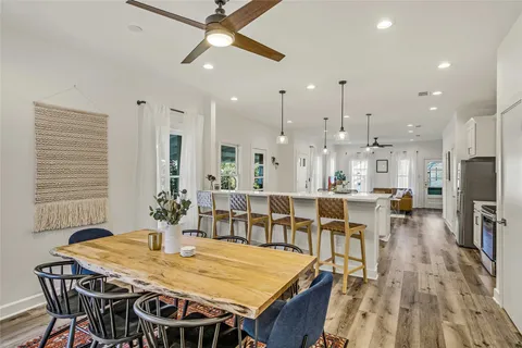 a very nice looking dining room with kitchen island a table and chairs