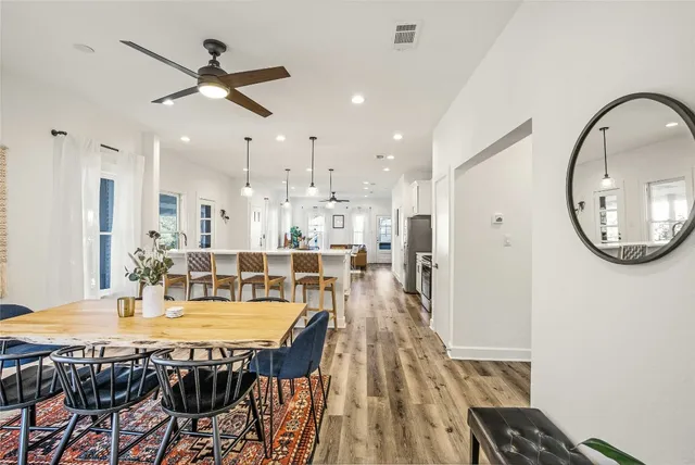 a view of a dining room with furniture and a chandelier