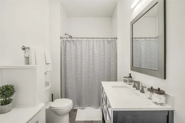 a bathroom with a sink toilet and shower
