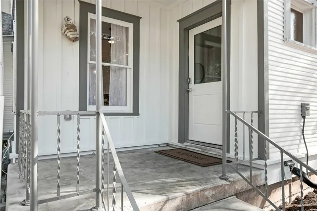 a view of a livingroom with wooden floor and windows