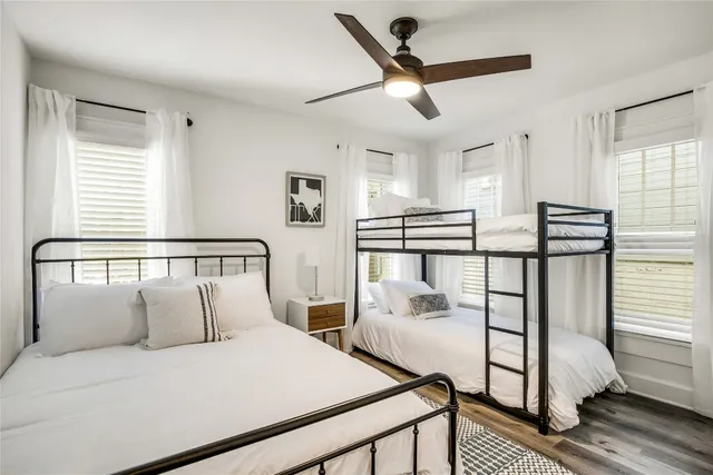 a bedroom with a bed and large window