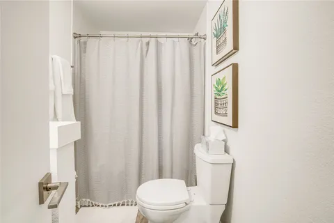 a white toilet sitting next to a white sink