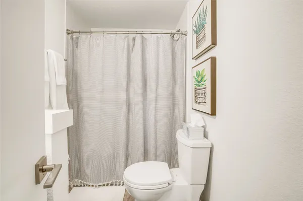 a white toilet sitting next to a white sink