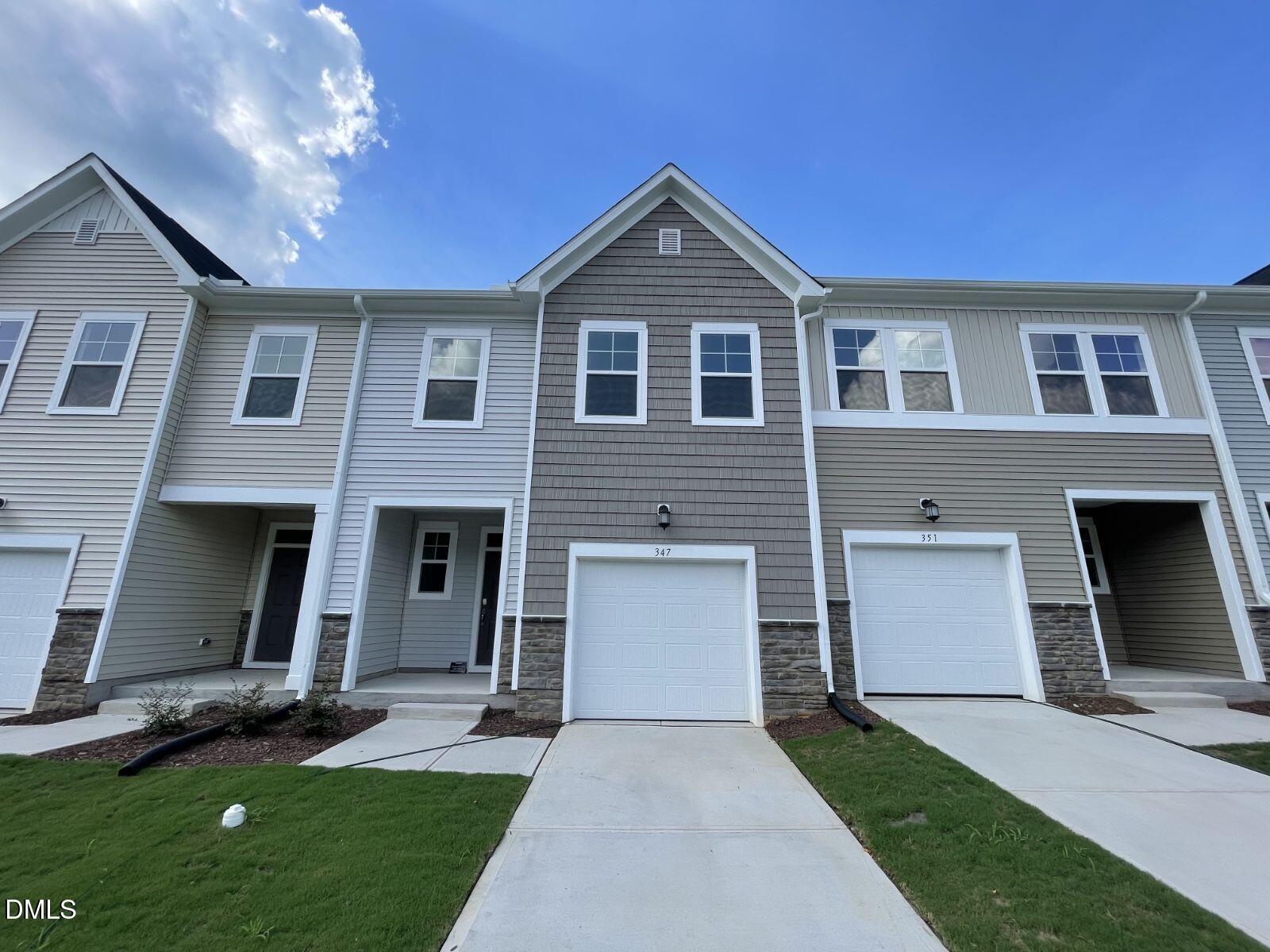 213 Lily Patch Lane Smithfield, NC 27577 - Photo 1 of 13 a front view of a house with a yard and garage