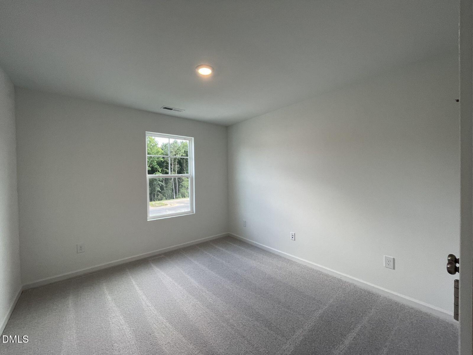 213 Lily Patch Lane Smithfield, NC 27577 - Photo 2 of 13 a view of an empty room with a window
