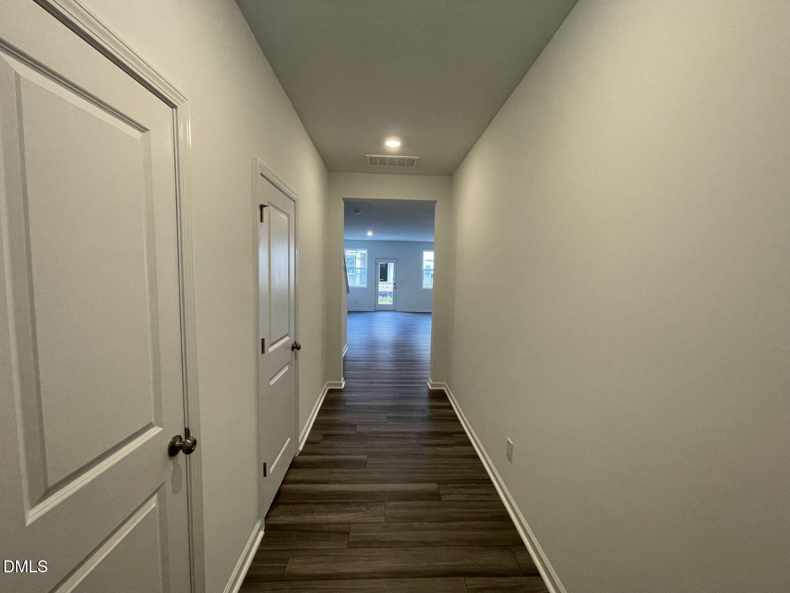 213 Lily Patch Lane Smithfield, NC 27577 - Photo 4 of 13 a view of a hallway with wooden floor and staircase