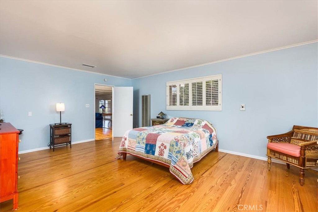 40057 South Shore Drive Fallbrook, CA 92028 - Photo 12 of 53 a bedroom with a bed and wooden floor