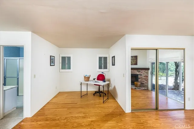 a kitchen with kitchen island a sink wooden floor and a large window