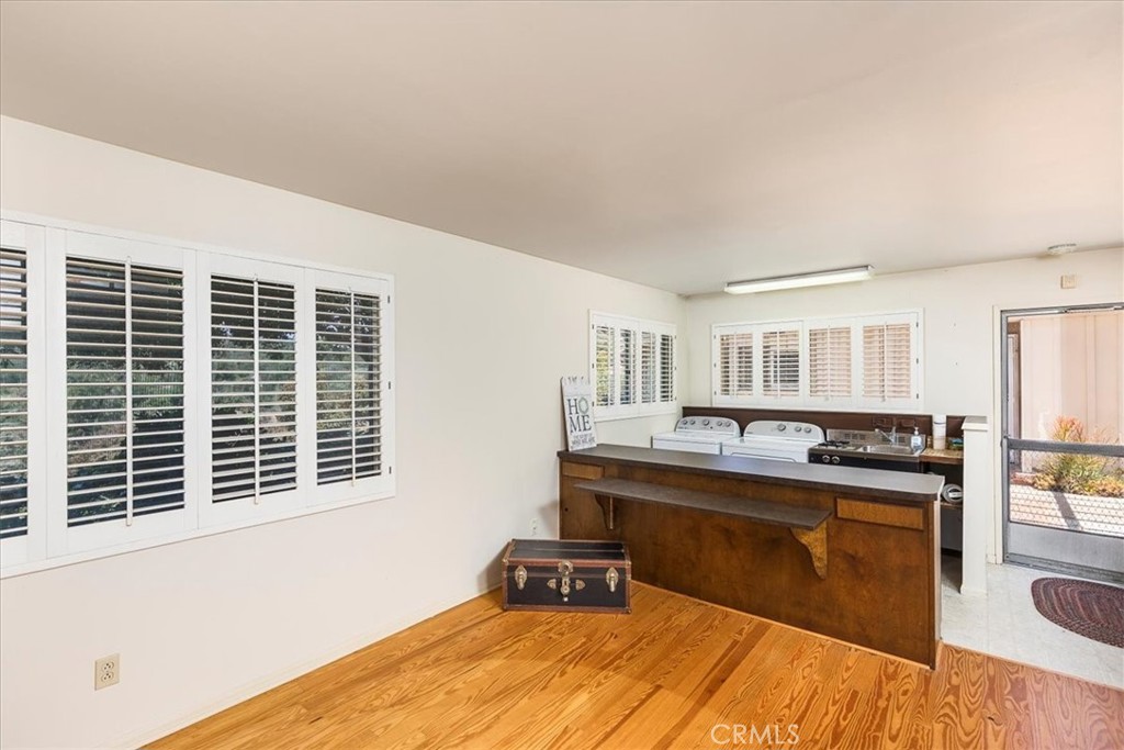 40057 South Shore Drive Fallbrook, CA 92028 - Photo 26 of 53 a kitchen with kitchen island a sink wooden floor and a large window