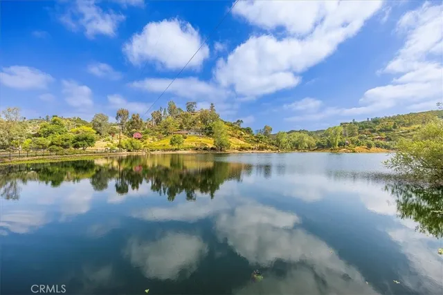 a view of a lake with houses in the back