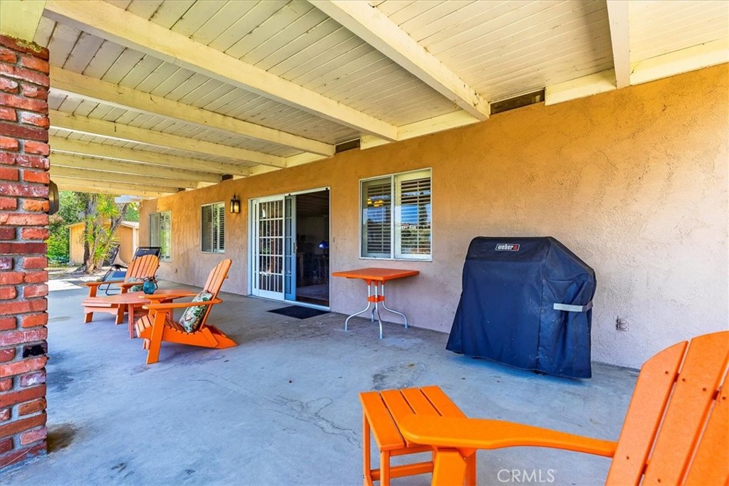 40057 South Shore Drive Fallbrook, CA 92028 - Photo 5 of 53 a backyard of a house with barbeque oven table and chairs