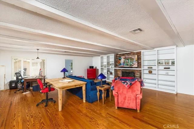 a living room with furniture fireplace and a window