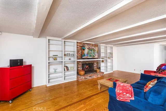 a view of a dining room with furniture a rug and wooden floor