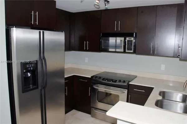 a kitchen with a stove microwave and sink