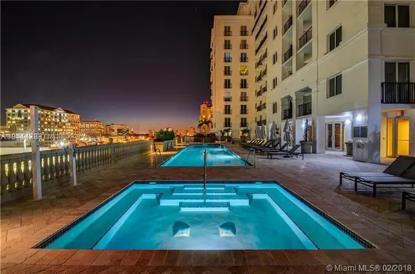 a couple of palm trees in front of house