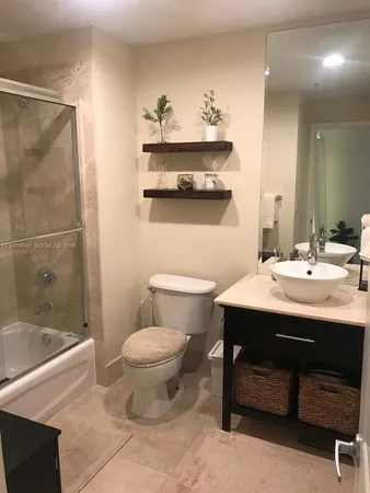 a bathroom with a sink mirror toilet and bathtub