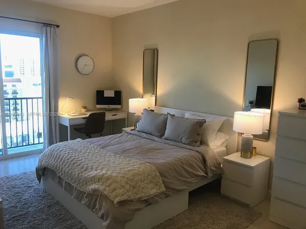 a bed room with a bed and a tv