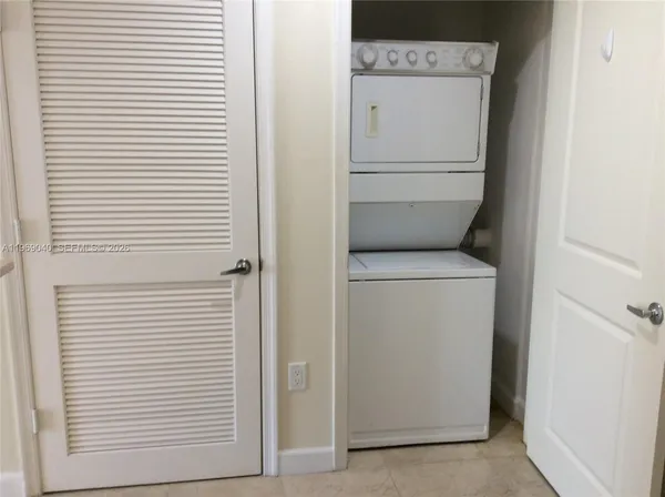a kitchen with granite countertop a stove top oven microwave and cabinets