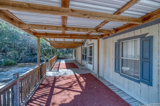 a view of empty room with fireplace and fan