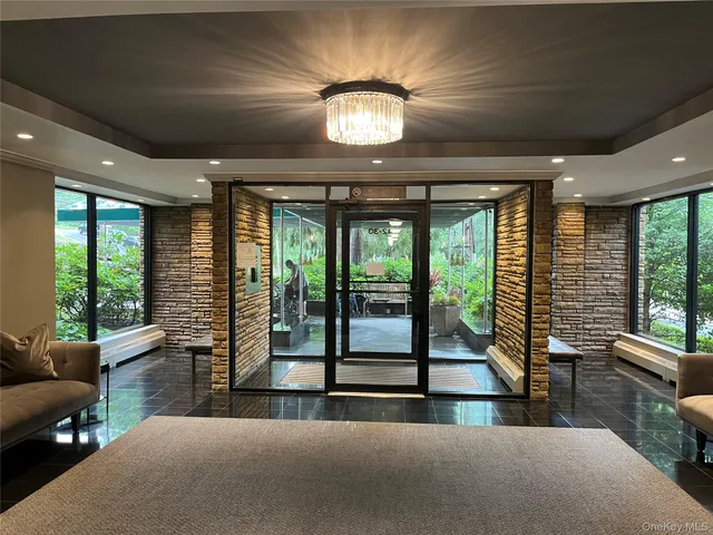 a living room with furniture and large windows