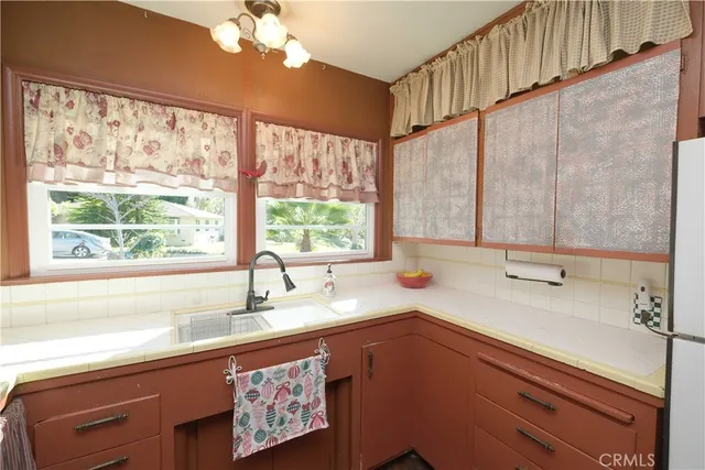 a kitchen with a sink a large window and a sink