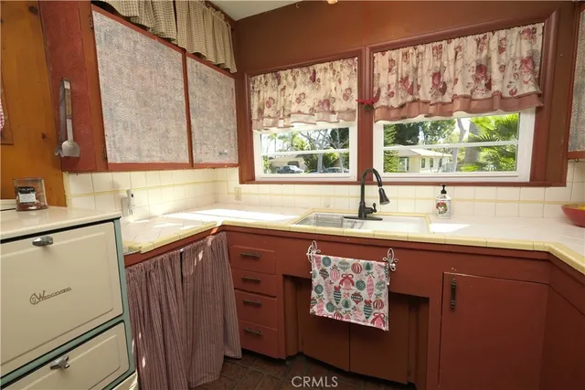 a kitchen with stainless steel appliances granite countertop a sink and a window