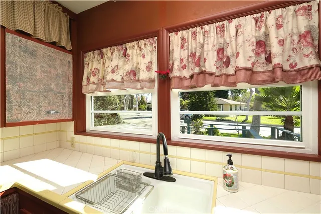 a bathroom with a bathtub and next to a window