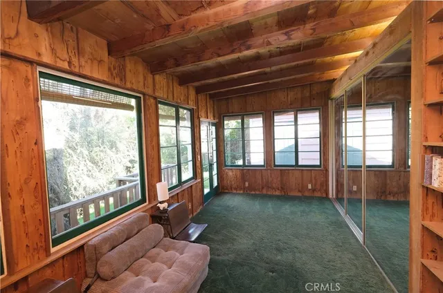 a view of an empty room with a fireplace and a window