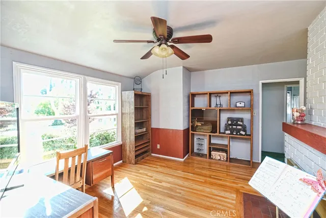 a view of a workspace with furniture and a window