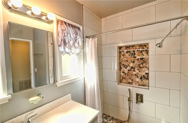 a view of a room with wooden floor and chandelier
