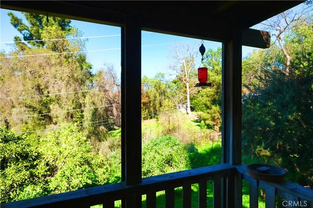 a view of balcony with wooden floor and outdoor seating