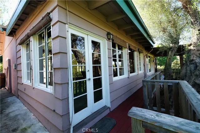 a view of front door and porch with wooden floor