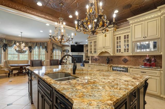 a view of a dining room with furniture wooden floor and a chandelier