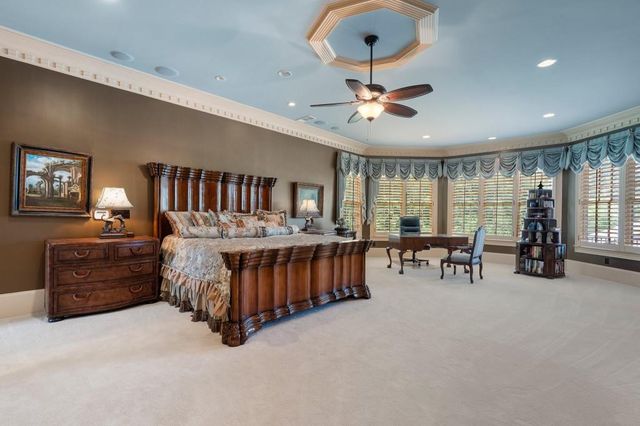 a living room with a fireplace and a chandelier