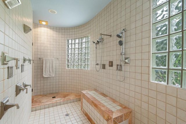 a spacious bedroom with bed and glass window