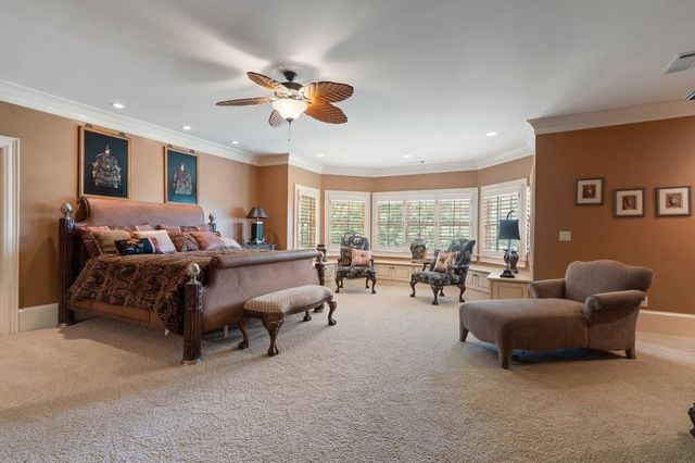 a living room with furniture a flat screen tv and a large window