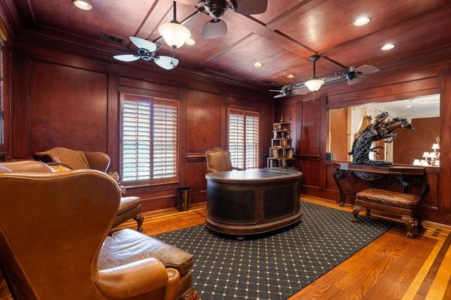 a kitchen with stainless steel appliances kitchen island granite countertop a table and chairs in it