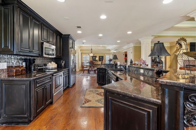 a view of house with swimming pool and yard