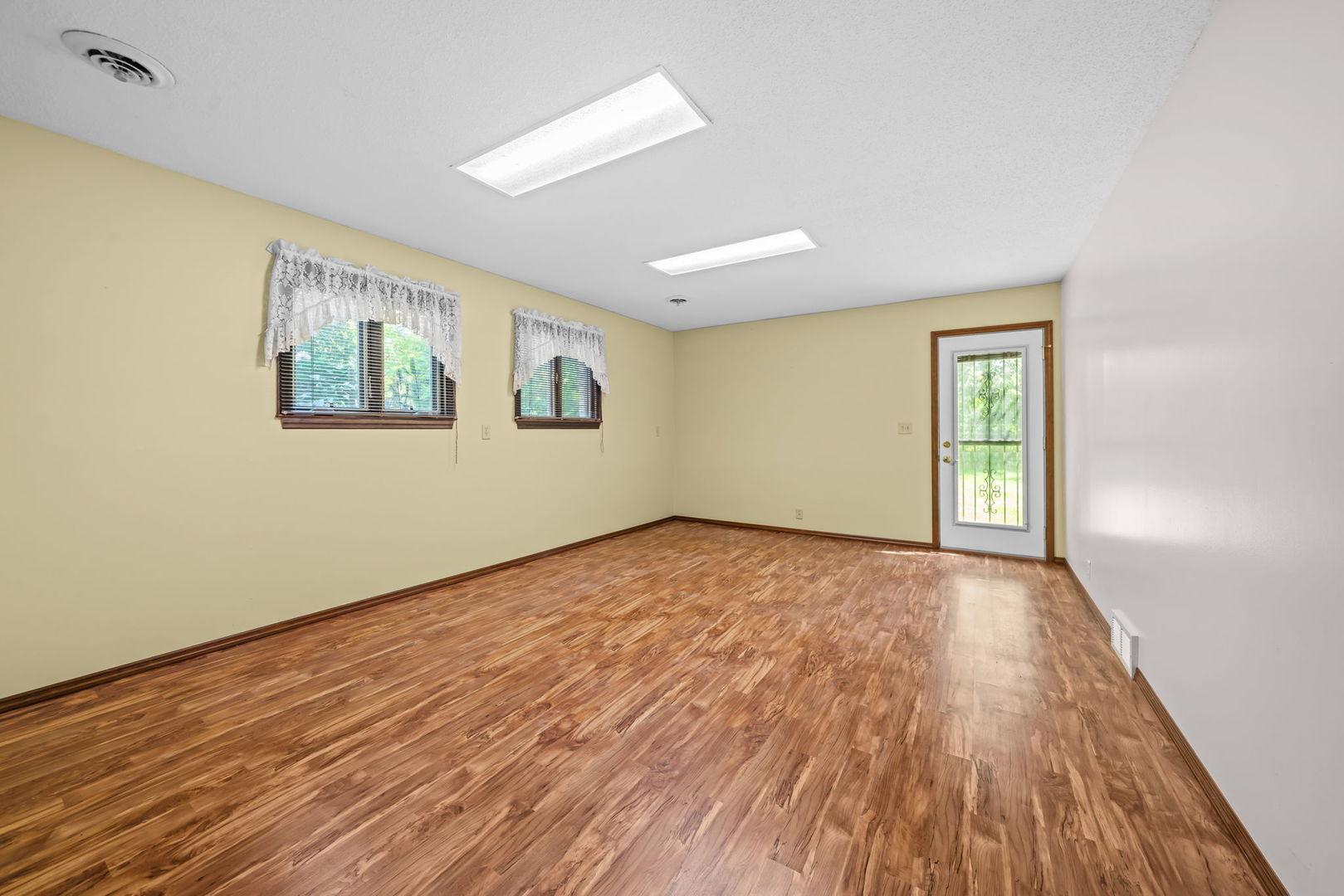 5748 South Skare Road Rochelle, IL 61068 - Photo 27 of 45 a view of an empty room with wooden floor and a window