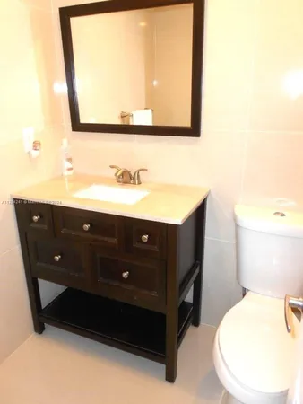 a bathroom with a sink a mirror and a toilet