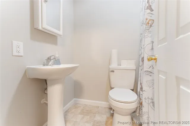 a bathroom with a sink toilet and a mirror