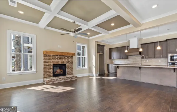 a kitchen with kitchen island granite countertop a stove and a sink