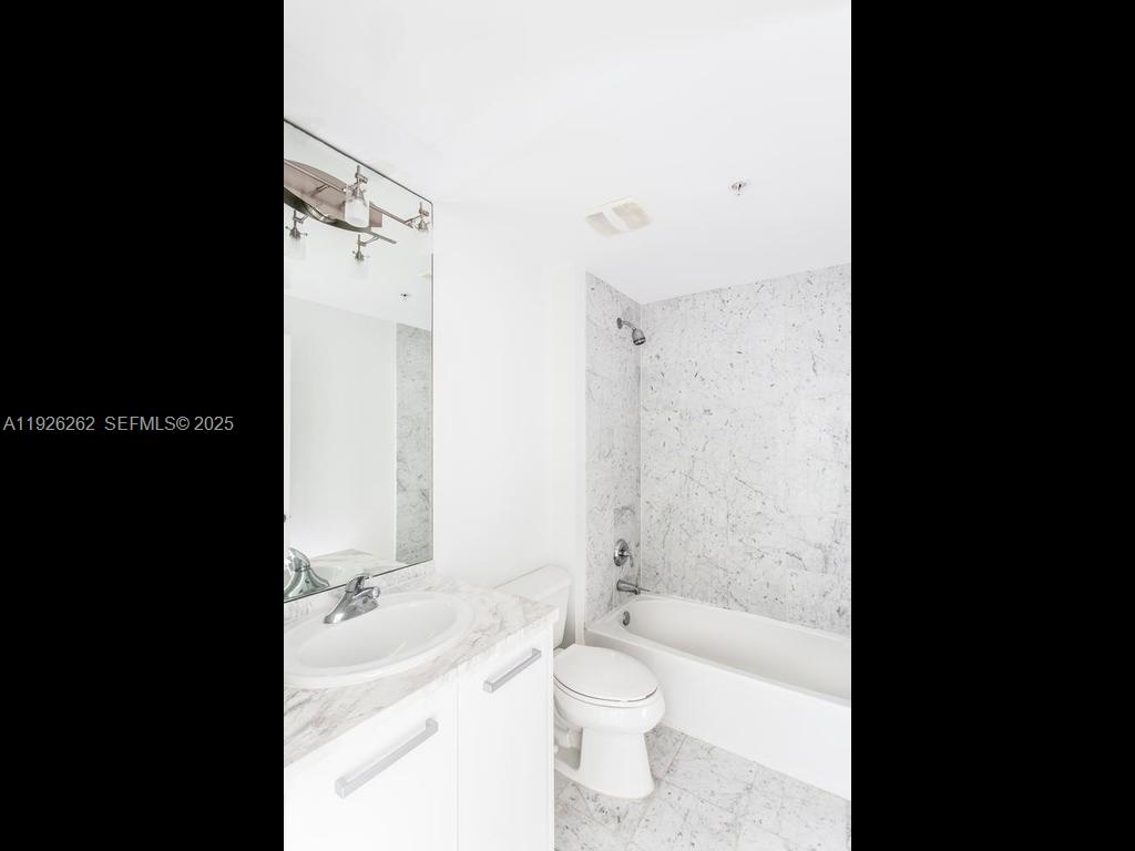 244 Biscayne Boulevard, Unit 1802 Miami, FL 33132 - Photo 14 of 14 a bathroom with a toilet a sink and bathtub