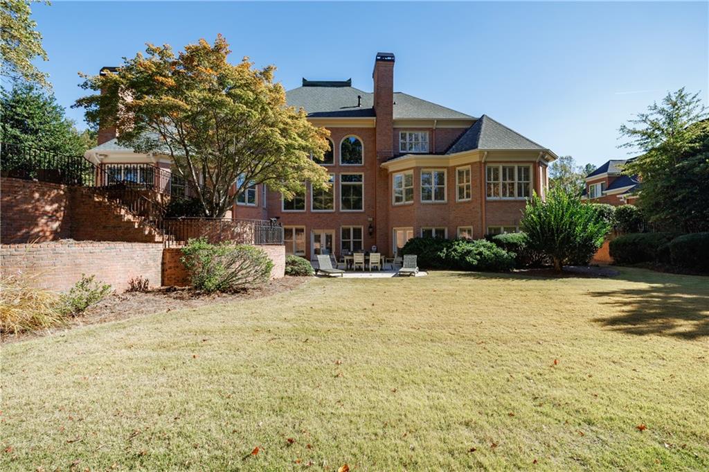 9390 Colonnade Trail Alpharetta, GA 30022 - Photo 122 of 122 a front view of a house with a yard and trees
