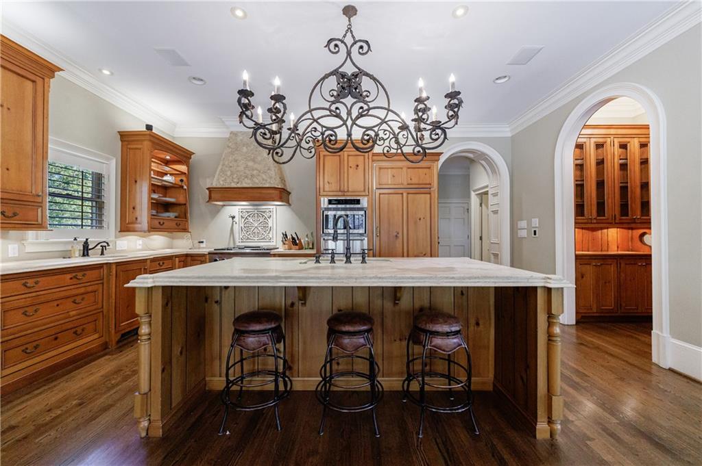 9390 Colonnade Trail Alpharetta, GA 30022 - Photo 19 of 122 a view of a dining room with furniture wooden floor and chandelier