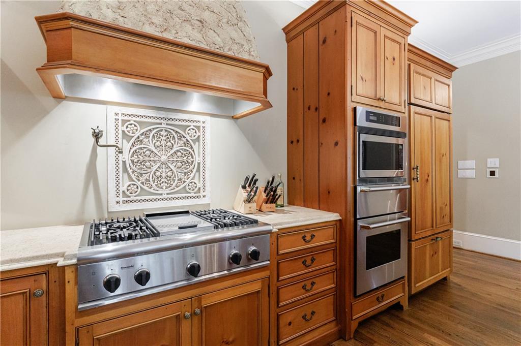 9390 Colonnade Trail Alpharetta, GA 30022 - Photo 22 of 122 a kitchen with stainless steel appliances granite countertop a stove and a refrigerator