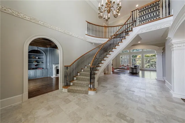 a view of a dining room with furniture a chandelier and wooden floor