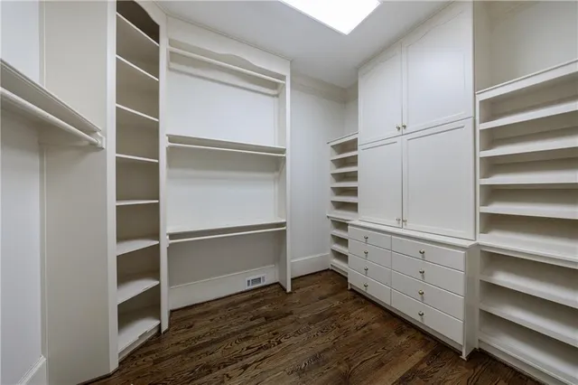 a living room with furniture and a walk in closet