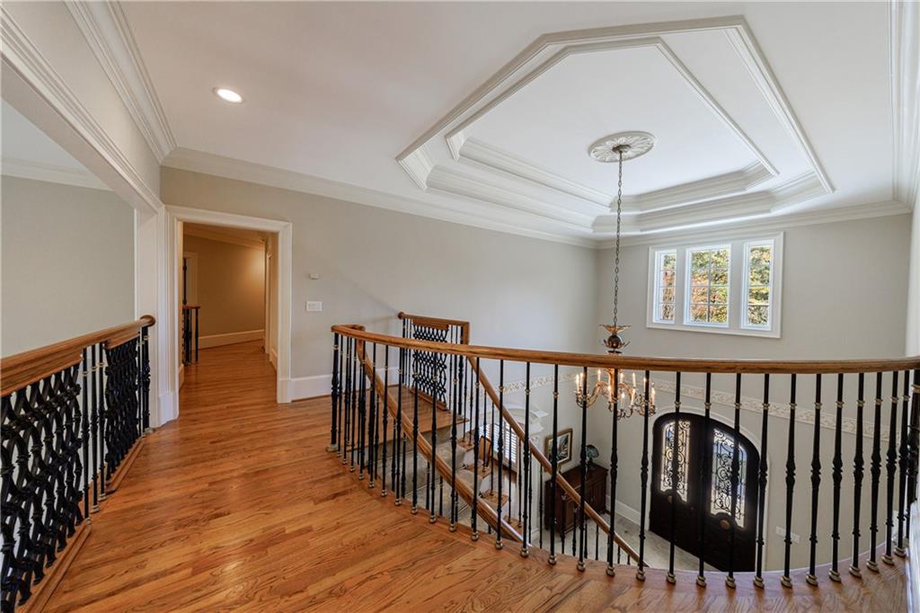 9390 Colonnade Trail Alpharetta, GA 30022 - Photo 50 of 122 a view of a hallway with wooden floor and staircase