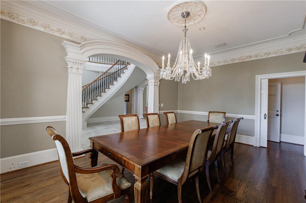 9390 Colonnade Trail Alpharetta, GA 30022 - Photo 7 of 122 a view of a dining room with furniture a chandelier and wooden floor